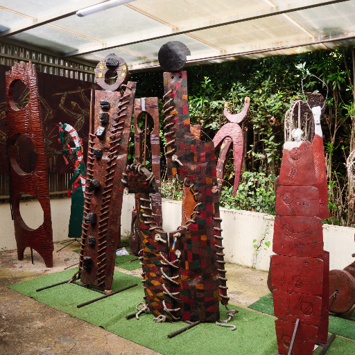 Dark carved wooden figures — interior installation