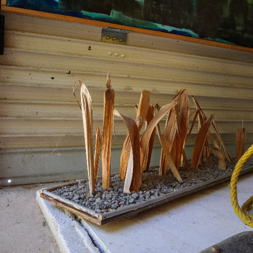 Wooden blade forms arranged in a gravel tray