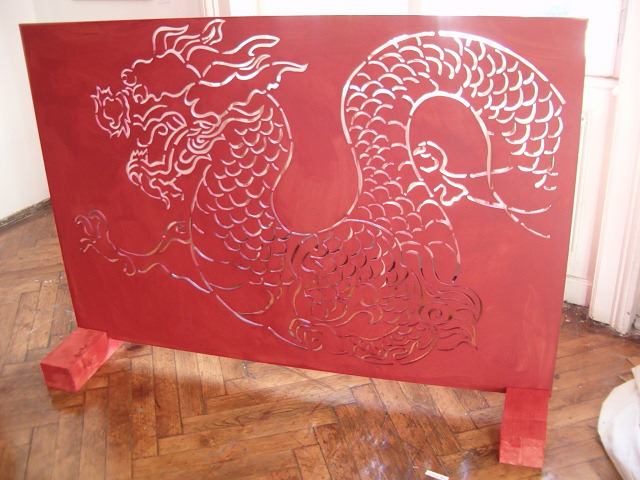 Dragon paravan — the cut-through MDF panel standing on its legs, light passing through the form